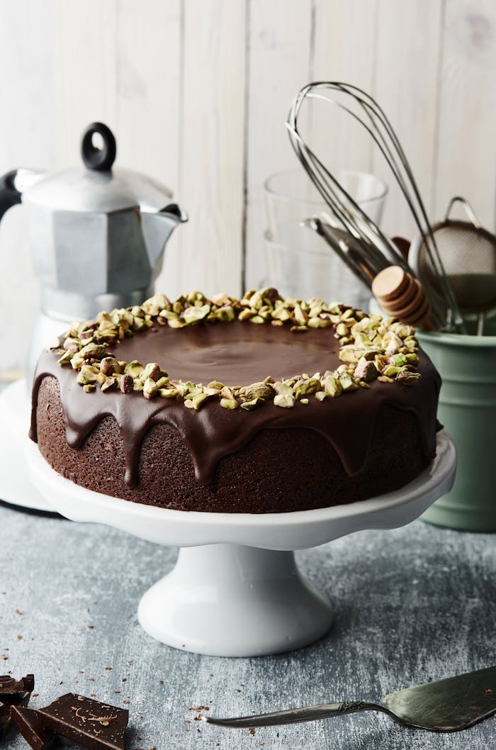 Indulge in this luxurious chocolate cake topped with crunchy pistachios.